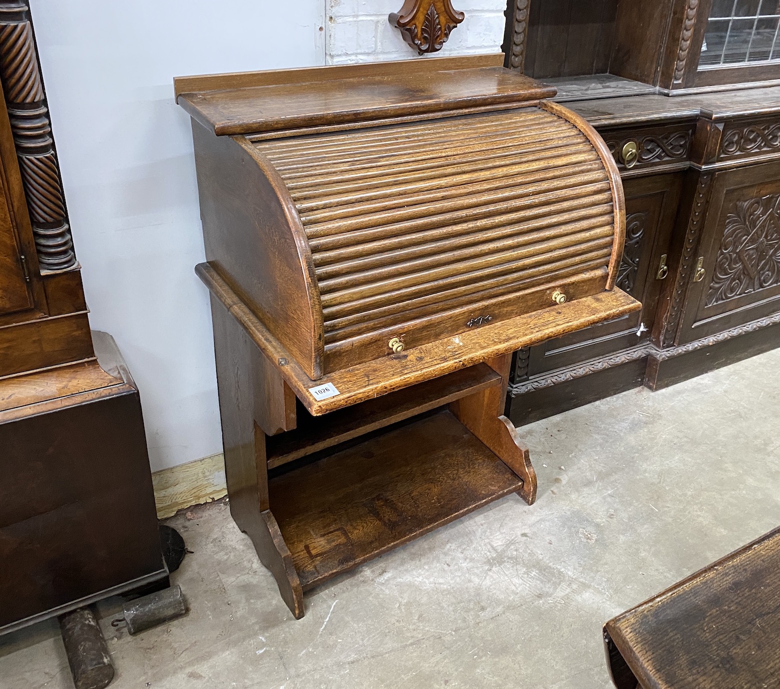 An early 20th century oval tambour roll top desk, combined bookcase, width 75cm, depth 53cm, height 108cm